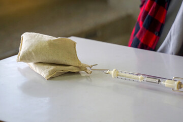 Asian students conduct experiments on friction Using a spring scale, pull 2 sandbags onto the...