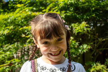 little child girl smiling outside in nature