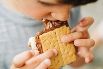 Close-up of a child eating a s'more