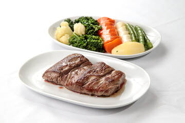 Grilled Filet Mignon with vegetables on plate