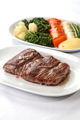 Grilled Filet Mignon with vegetables on plate