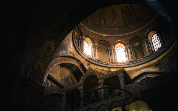 Sunlight streams through an open window in an ancient church