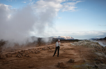 Young woman walks in Myvatn Geothermal Area, Iceland