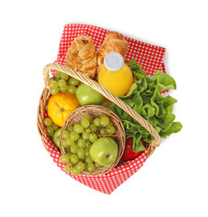 Picnic basket with checkered napkin, food and juice isolated on white, top view