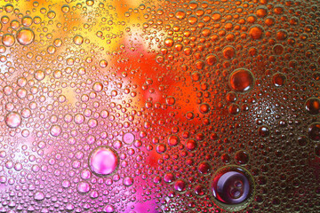 Essential oil bubbles on color background, macro view. Cosmetic product
