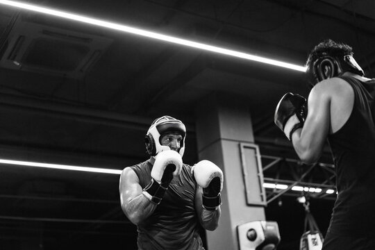 Boxers fighting in boxing training in the gym.