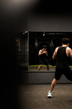Man warms up before training in the gym.