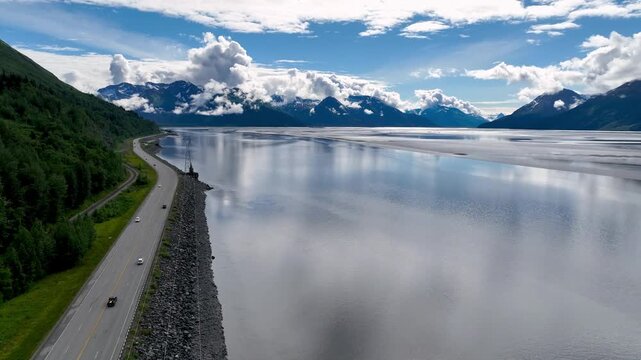 aerial of cars on highway along the turnagain arm in alaska
