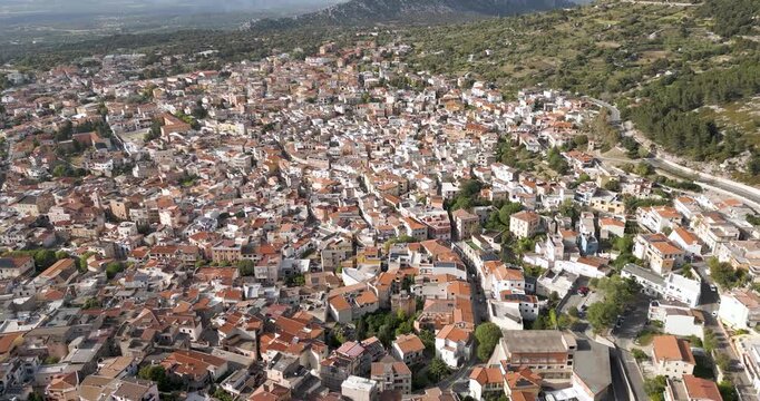 Aerial View Of Residential Village In Mountainous Town Of Dorgali In Sardinia, Italy. tilt-down shot