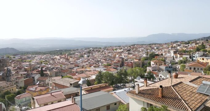 Aerial View Of Town Of Dorgali In Province Of Nuoro, Sardinia, Italy. Foggy Mountain In Background.