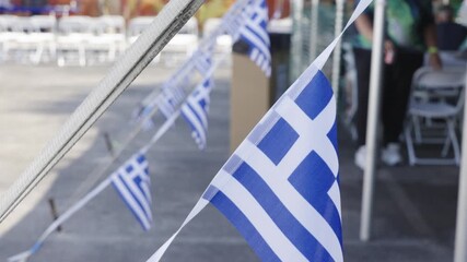 Breeze lightly moving the flags in slow motion. - Powered by Adobe