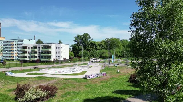 Residental area uring a beautiful summer day surrounded by lush greenery, grass, and trees under a blue sky