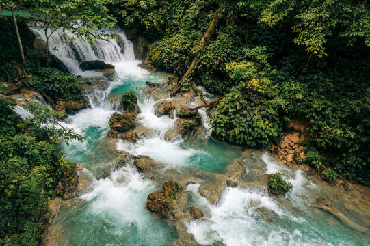 Refreshing waterfall and cascades with lush vegetation at Air Terjun Laumarang in Indonesia; Bukit Mambual, Luwuk, Banggai Regency, Central Sulawesi, Indonesia
