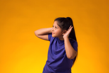 Kid girl eavesdropping, overhearing confidential secret conversation, keeping hand at his ear....