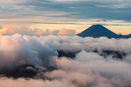 Peak of Mount Semeru above the clouds at twilight in Bromo Tengger Semeru National Park, Indonesia; Ranupani, East Java, Indonesia
