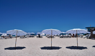 White Umbrellas and Hammocks at Miami Beach: Relax in Tropical Paradise