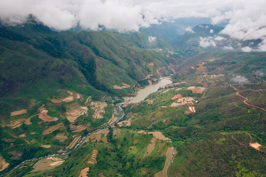 Terraced farmland with a lake and river in the valley of a mountainous terrain, Vietnam; Nam Pam, Muong La District, Son La, Vietnam