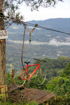 Bike suspended from cables and pulley for a thrilling zip-line ride over a forest in the Rante Pao area of North Toraja, Sulawesi, Indonesia; North Toraja, South Sulawesi, Indonesia