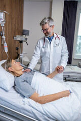 Fototapeta premium Doctor talking to a patient in clinic and looking involved and concerned