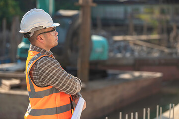 Construction engineer working on a bridge construction site over a river,Civil engineer supervising...