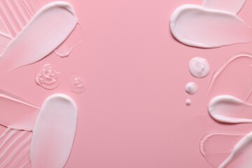 Samples of face cream on pink background, top view. Space for text