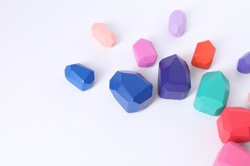 Many colorful balancing stones on white background