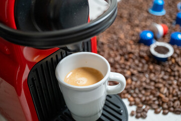 making coffee in a cup in a capsule coffee machine