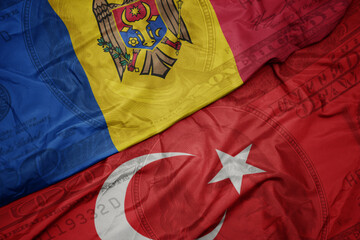 waving colorful flag of moldova and national flag of turkey on the dollar money background. finance...