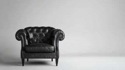Black leather armchair on a white background. The armchair is classic in style with a tufted seat and back.