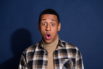 Photo portrait of handsome young man amazed staring dressed stylish plaid garment isolated on dark blue color background