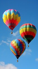 Naklejka premium Three Colorful Hot Air Balloons In The Blue Sky