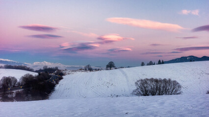 Meadows covered by the snow during snowy winter with High Tatras mountains at background in Slovakia