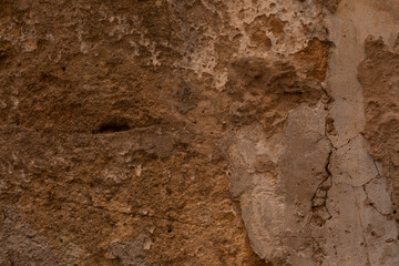 A weathered wall with patches of peeling paint
