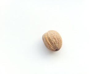 One raw nutmeg seed.