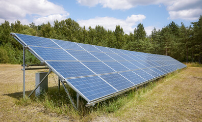 Photo of photovoltaic panels in a field, selective focus.