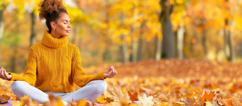 Serene individual practicing yoga meditation surrounded by vibrant autumn leaves in a peaceful park during Mental Health Awareness Week 