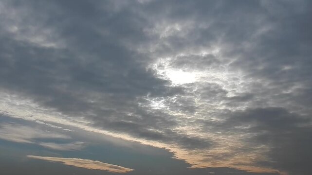 Sky with texture of clouds Altocumulus stratiformis slowly moving and sunlight after sunrise - natural sky background. Topics: weather, atmosphetre, meteorology, calm, morning