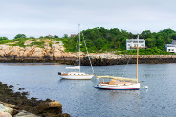 Two anchored sailboats in Rockport Harbor on an overcast day, Rockport, Massachusetts, USA