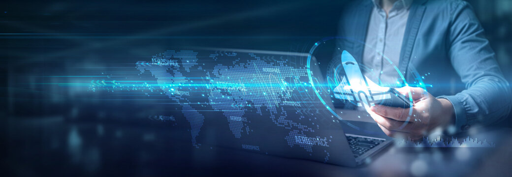 Businessman using laptop and mobile on global network connection of aerospace innovation, Globalization advancements and aerospace technology, international business, and aerospace logistics.