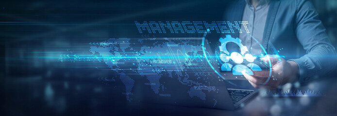 Businessman using laptop and mobile on global network connection of management solutions, management information systems, management technology, management business, and strategic management. © Harsha