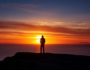 Obraz premium A lone figure silhouetted against a vibrant sunset, contemplating the horizon