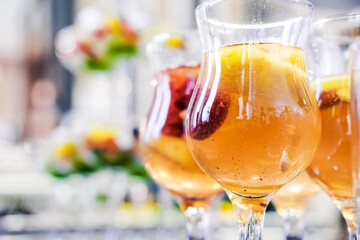 Close-Up of Refreshing Fruit Punch in Glasses. Close-up of glasses filled with refreshing fruit punch, highlighting vibrant fruits inside the drink. Horizontal shot.
