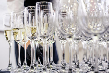 Glasses of Champagne at a Formal Event. Multiple glasses of champagne arranged neatly, ready for serving at a formal event. Horizontal shot.