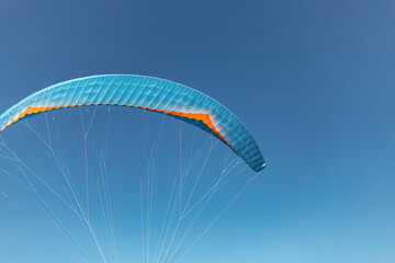 Colorful paraglider close-up against the blue sky
