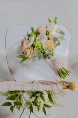 wedding bouquet with chiffon ribbon on a chair