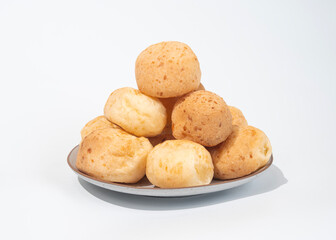 stack of Cheese bread on the plate, Brazilian pao de queijo mineiro, white background