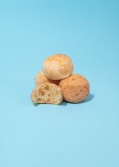 four Brazilian cheese breads - pao de queijo on the blue background