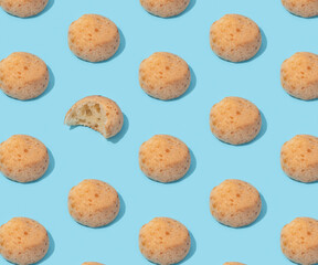 Food pattern with Brazilian cheese buns on the blue background, minimalism with hard shadows