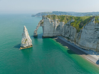 Aerial view of Etretat cliffs and the Atlantic ocean. Chalk cliffs and three natural arches....