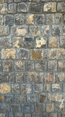 Cobblestoned pavement background. Stone pavement texture. Abstract background of stone path close-up.